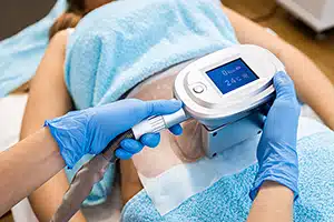 Female patient receiving cryolipolysis treatment